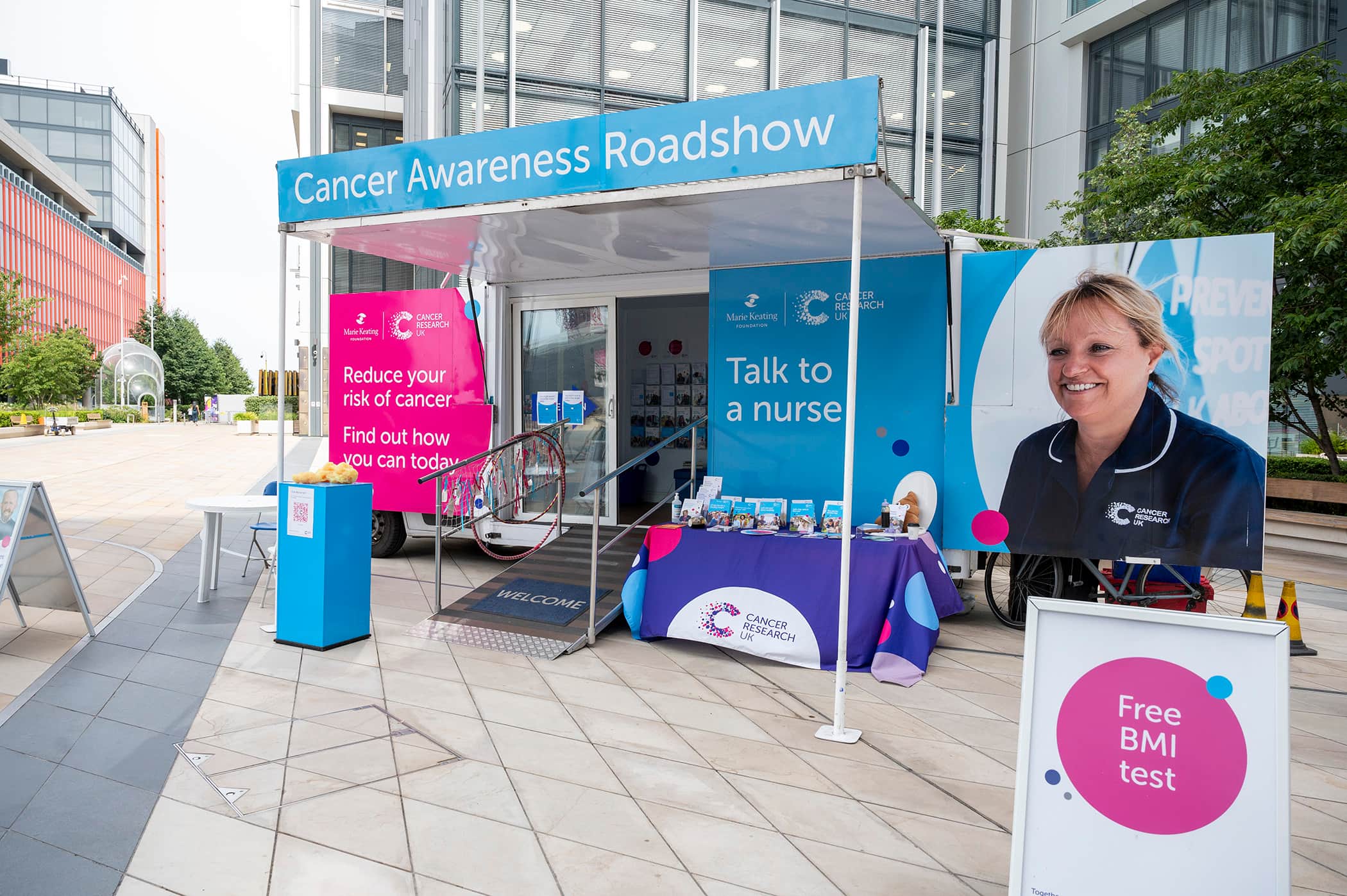 A photo of the Cancer Awareness Roadshow stand surrounded by offices.