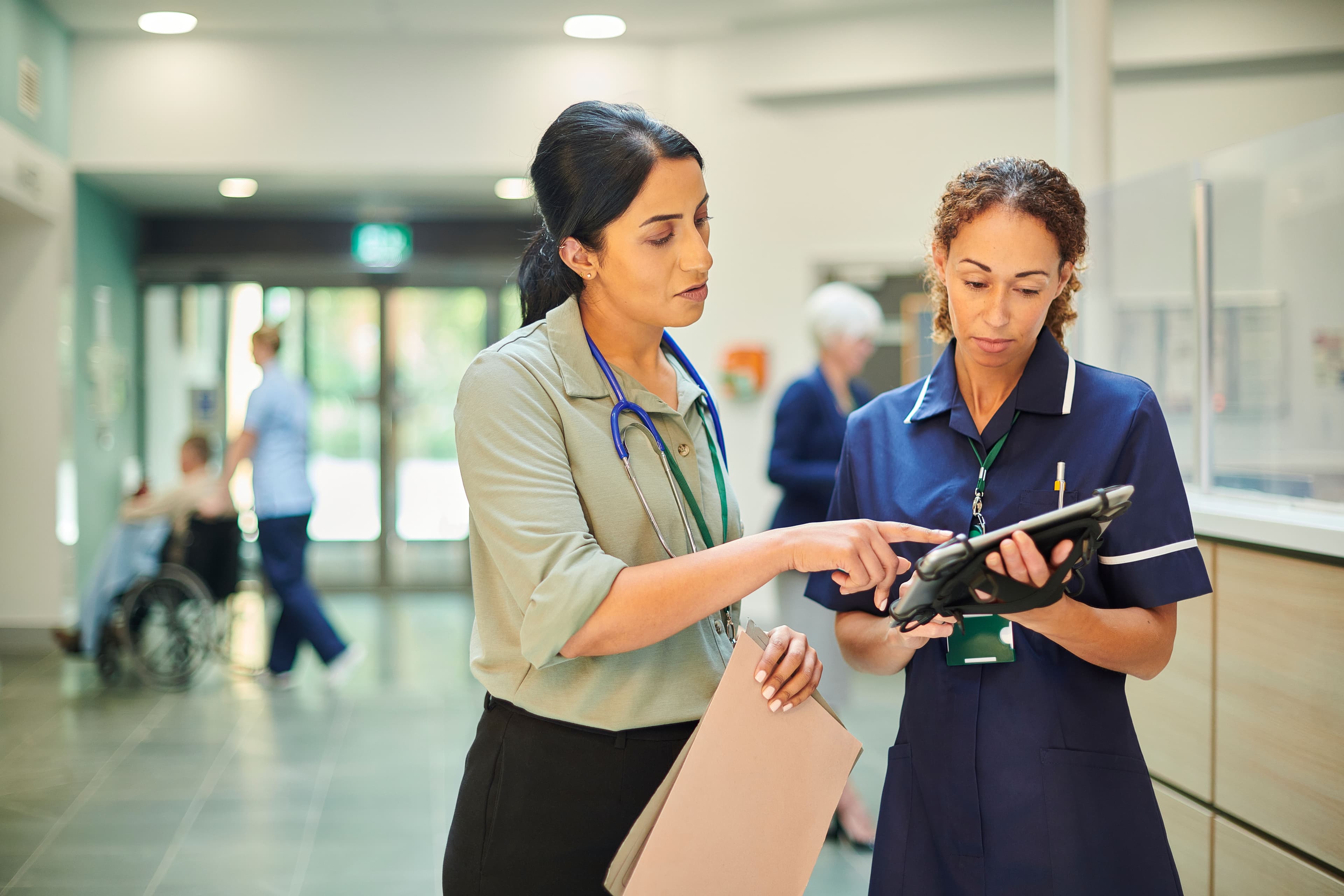 Photo of doctor and nurse talking.