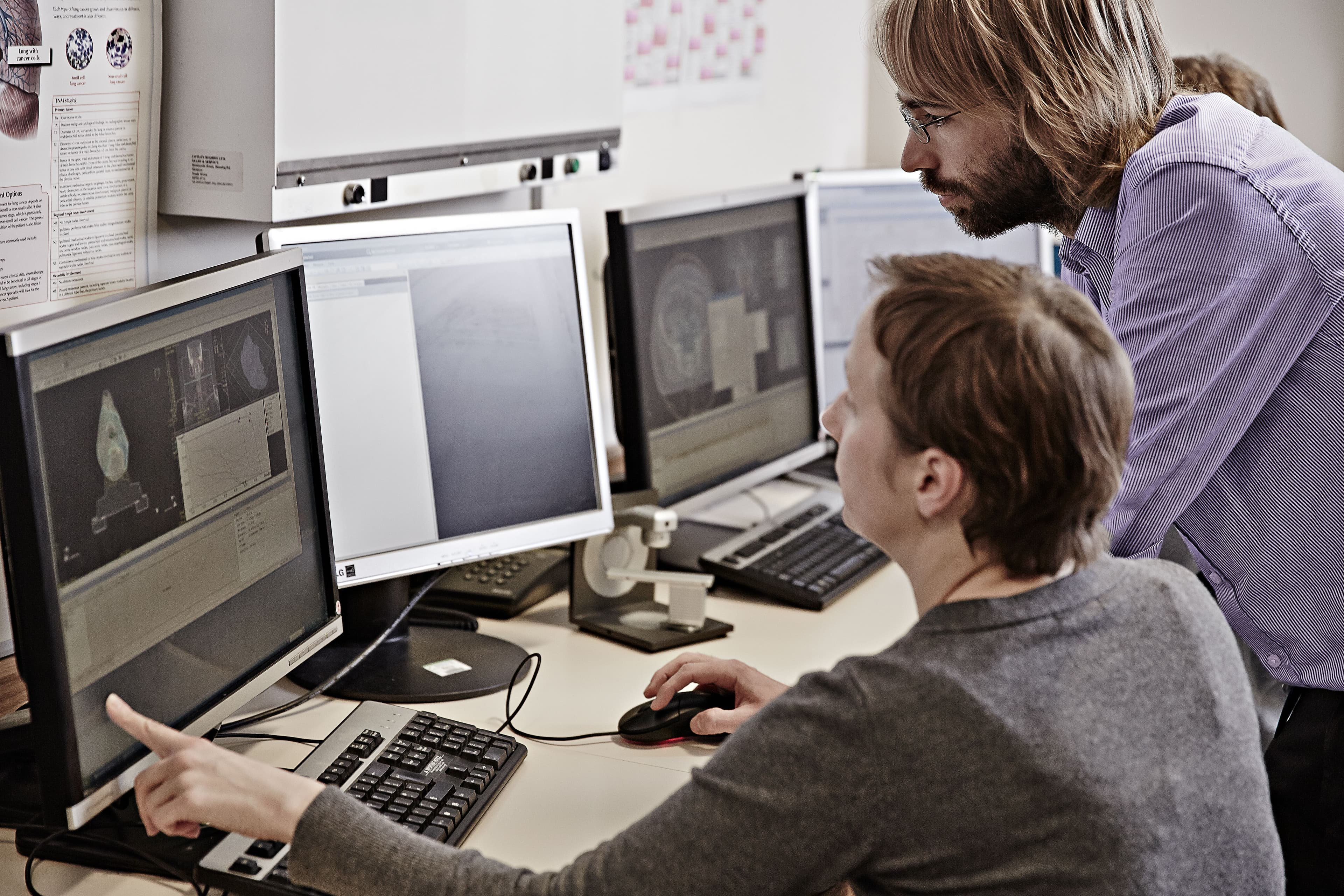 Photo of two men looking at a computer screen.